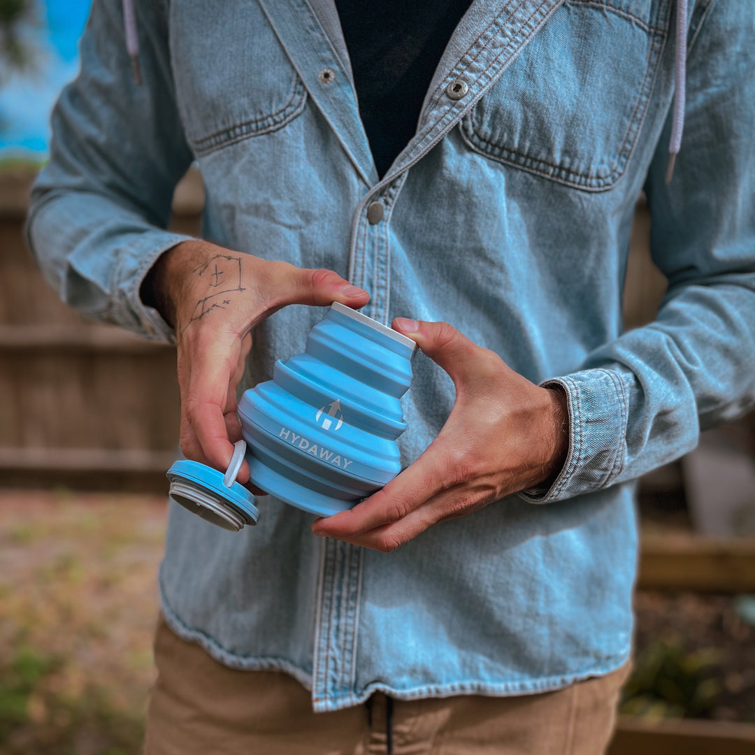 A man collapsing a HYDAWAY collapsible water bottle
